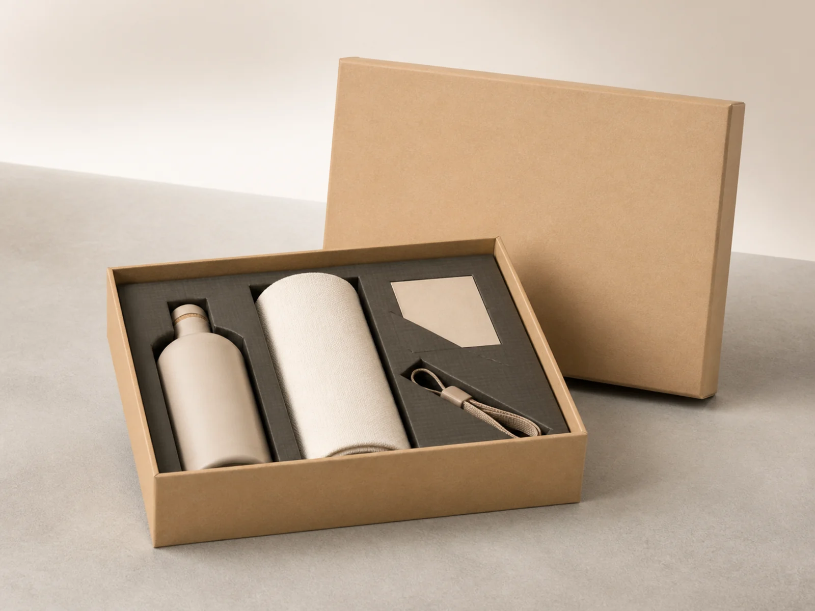 Opened welcome kit box in natural cardboard with a bottle and towel